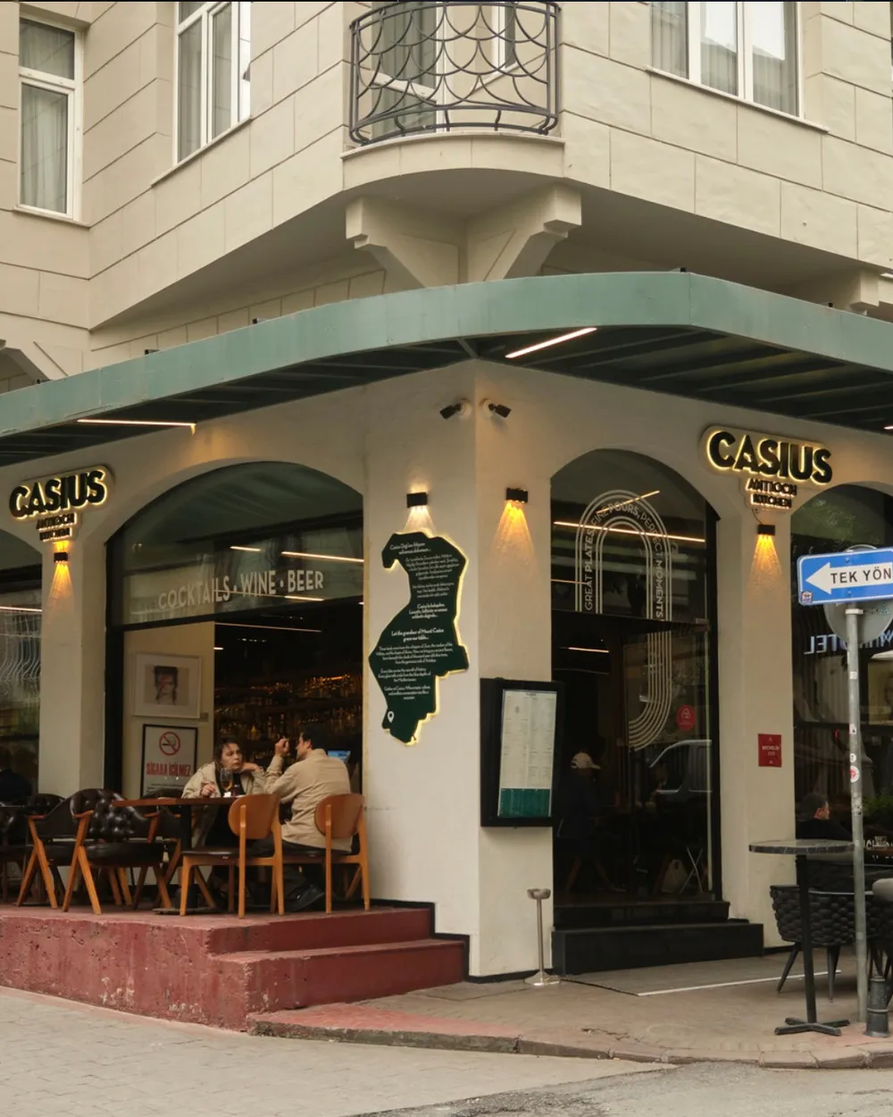 Casius Antioch Kitchen corner façade with arched windows and terrace tables in Cihangir, Istanbul