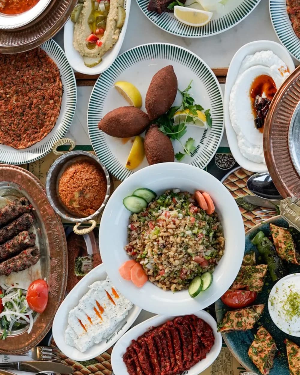 Gaziantep table of lahmacun, içli köfte, kebab, çiğ köfte, hummus and walnut salad, Karaköy