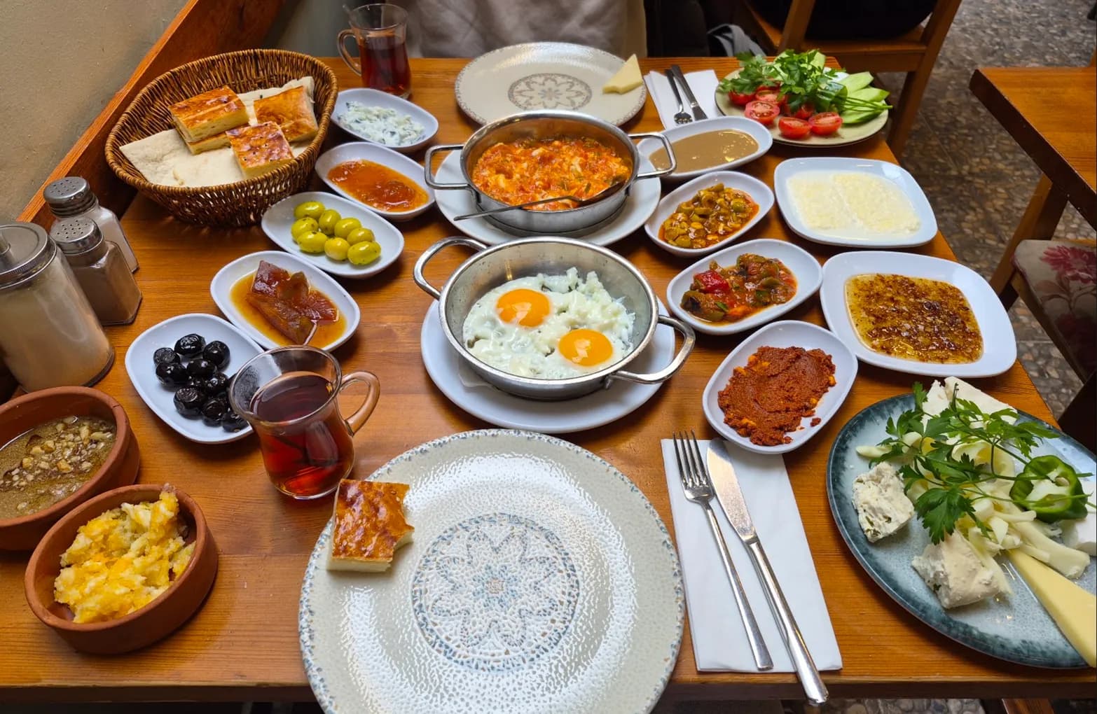 Van-style breakfast with otlu peynir, kaymak, murtuğa, kavut and eggs in the pan, Cihangir, Istanbul