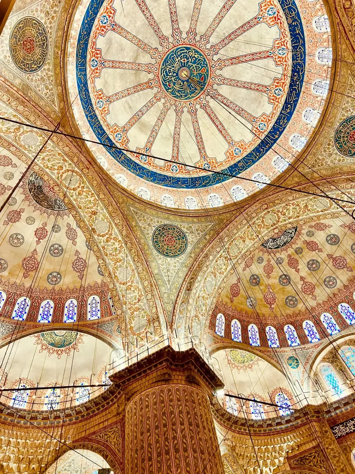 The majestic courtyard and monumental entrance of the Sultanahmet Mosque in Istanbul.