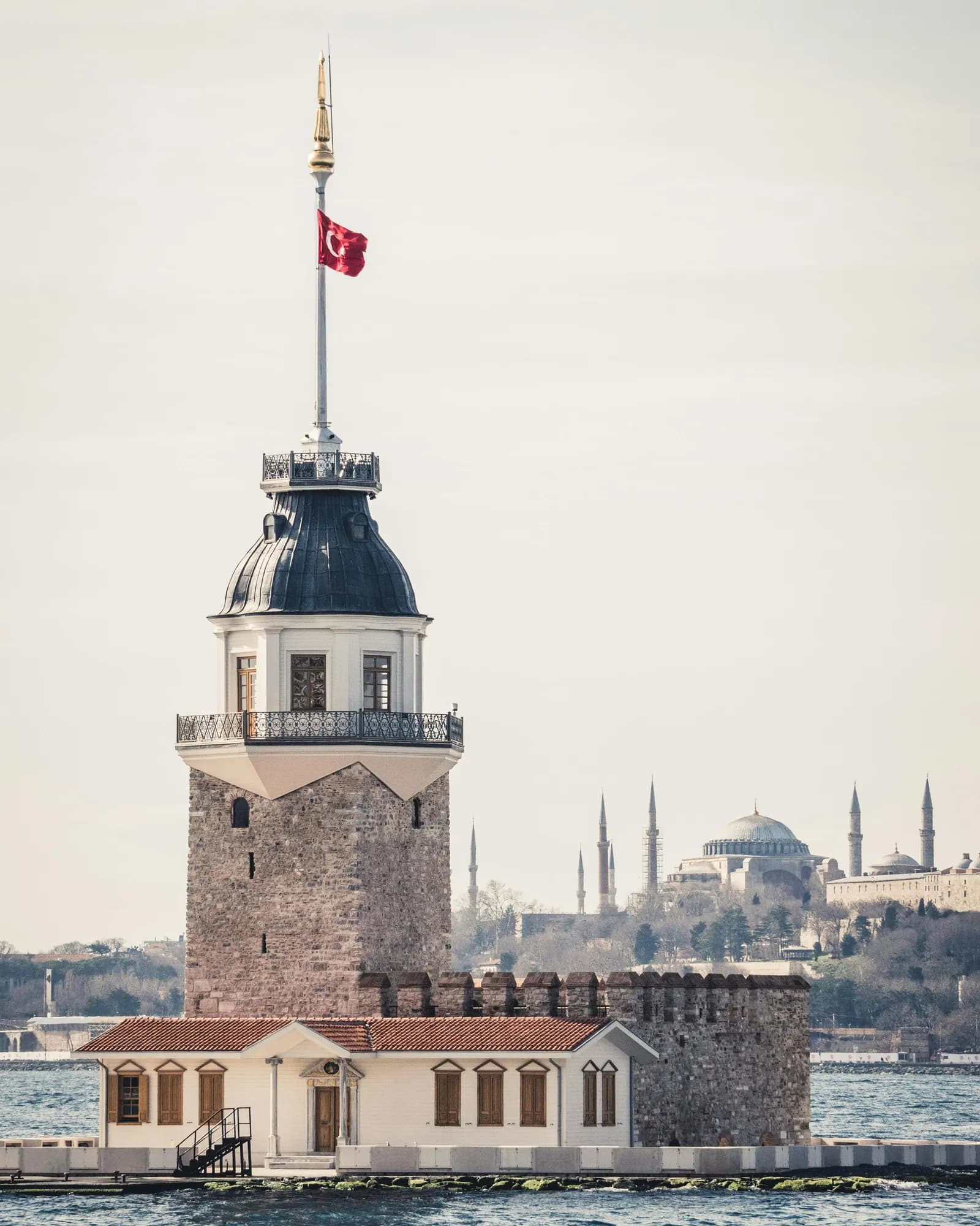 The legendary Maiden's Tower (Kiz Kulesi) standing gracefully in the Bosphorus A historic symbol of love and ancient legends.