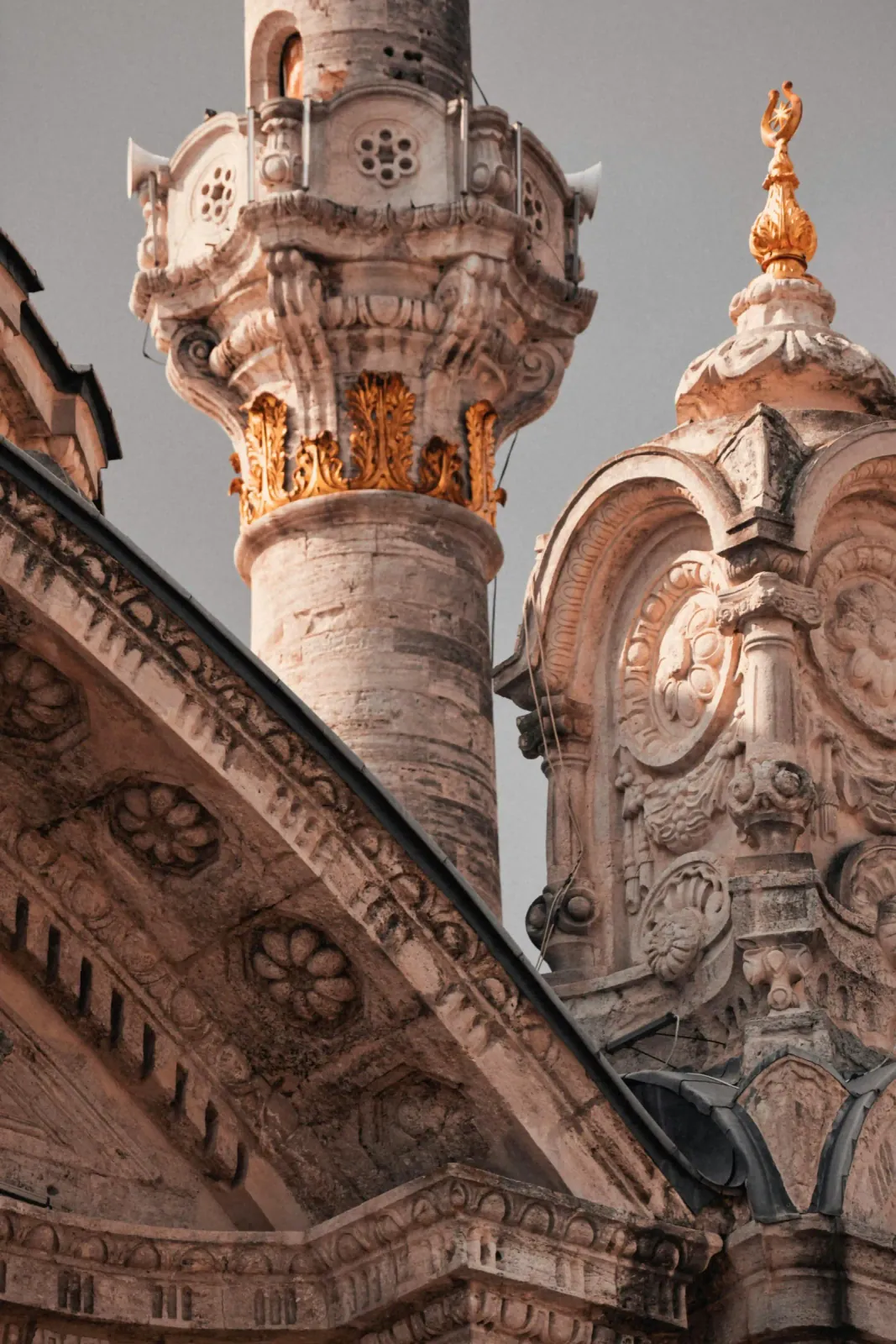 Close-up of the Baroque stone carvings and elegant minarets of Ortakoy Mosque. Explore 19th-century Ottoman architecture while.