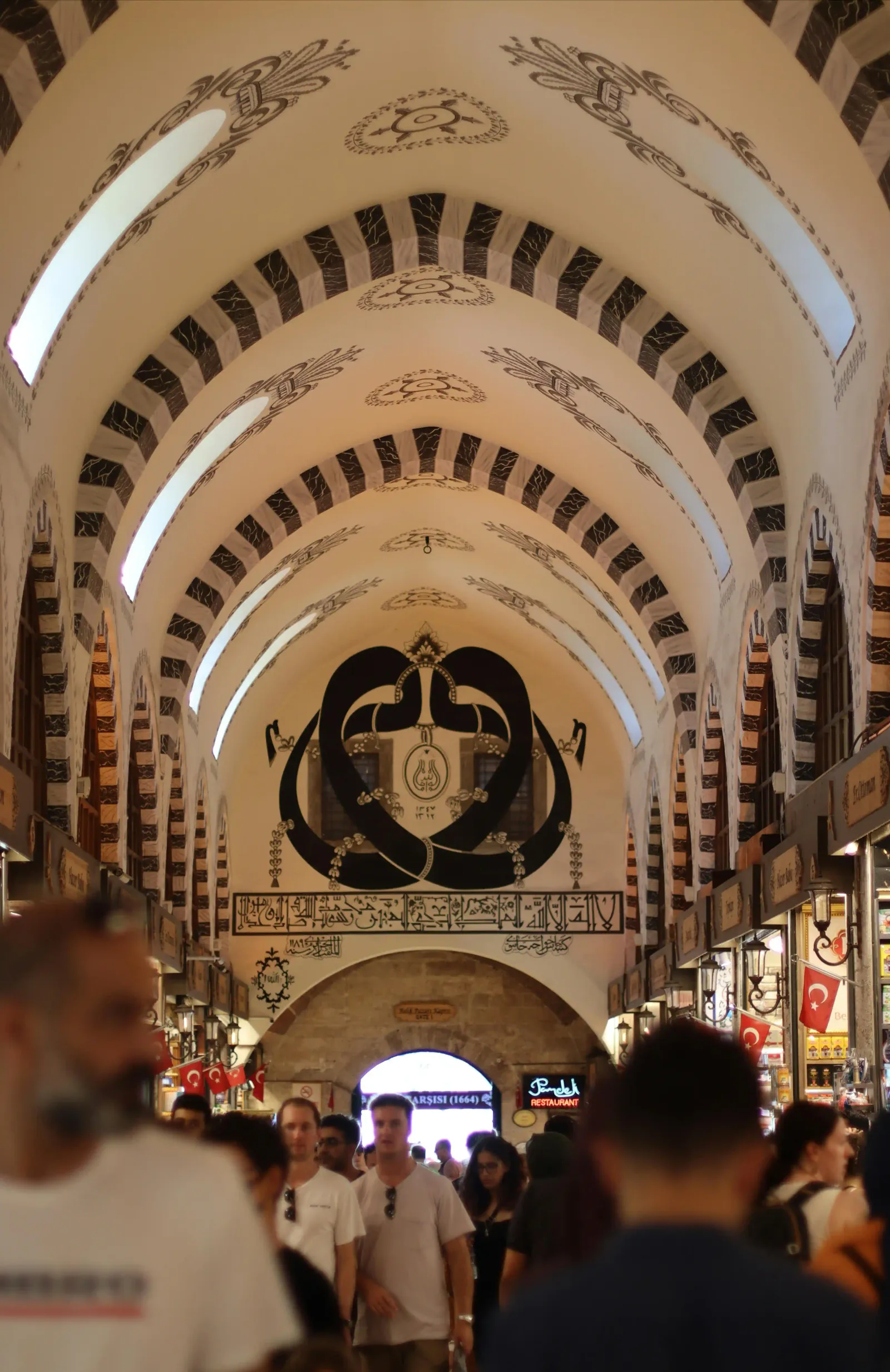 The bustling central corridor of the Spice Bazaar featuring traditional shops and arches. A historic shopping.
