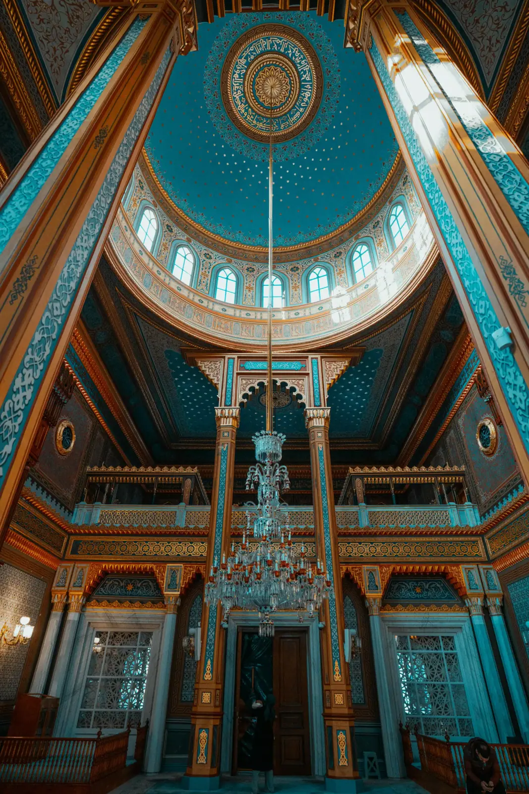 Looking up at the celestial dome and crystal chandeliers of Yildiz Hamidiye Mosque.