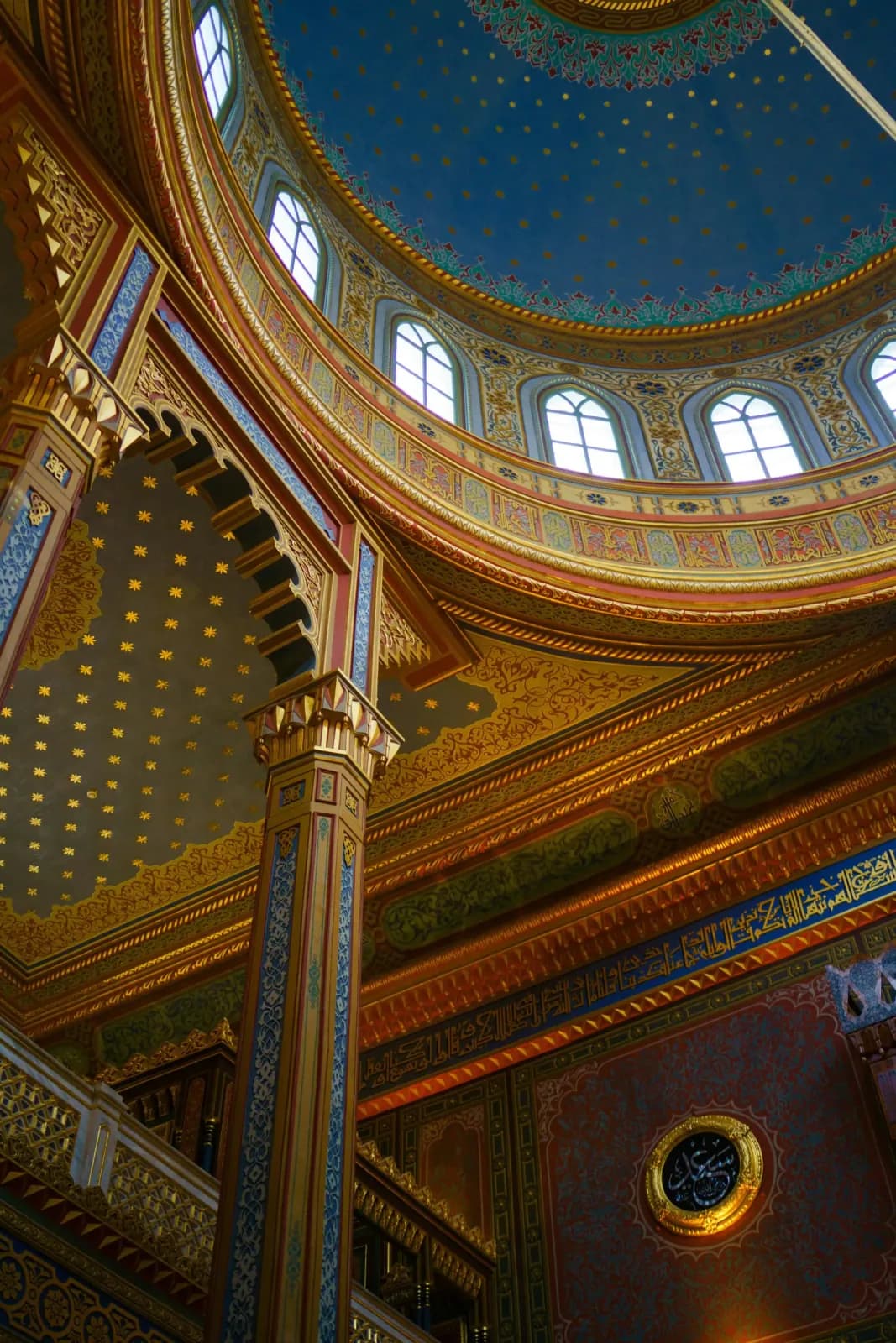 Interior perspective of Yildiz Hamidiye Mosque showing the vibrant blue dome and gold leaf stars.