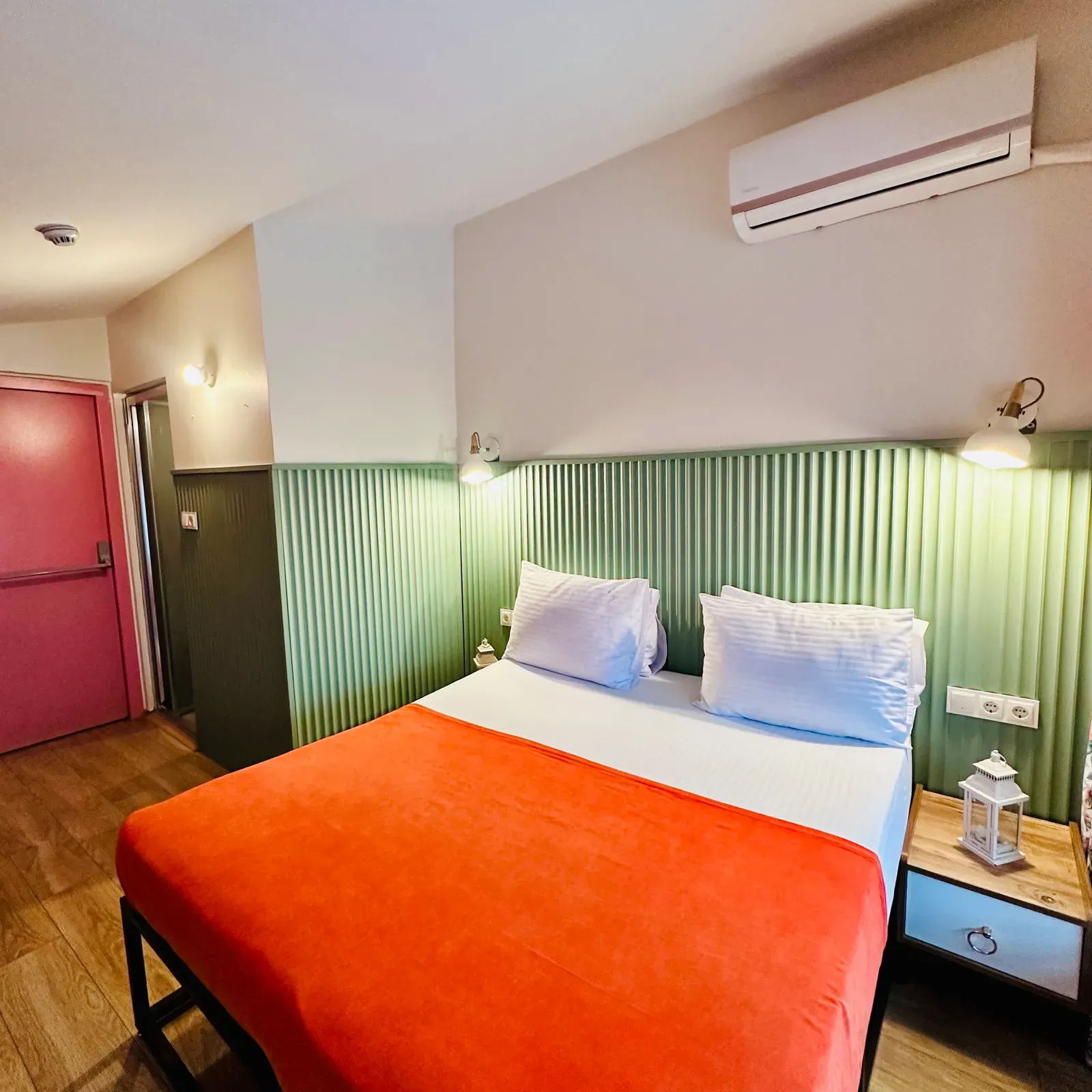 Room with Balcony — double bed, sage fluted headboard and orange throw, Karaköy, Istanbul