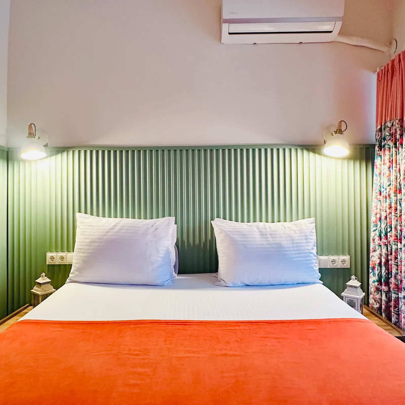 White lanterns and floral drapes beside the bed in the Room with Balcony, Karaköy, Istanbul