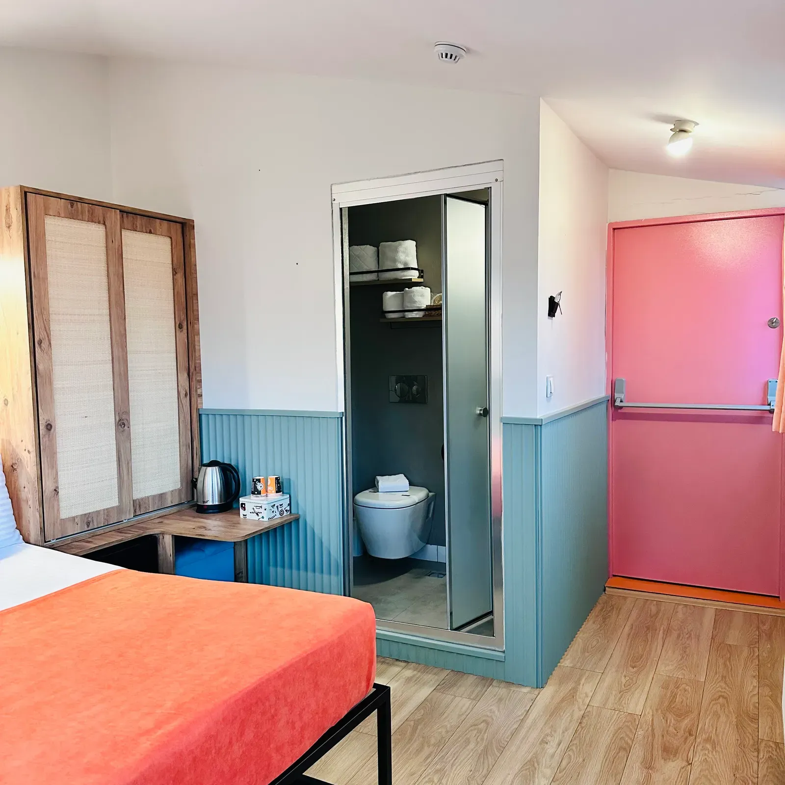 Ensuite bathroom, wardrobe and coral bedspread in the Room with City View, Karaköy